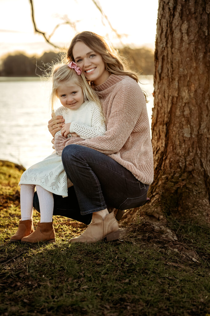 Family Portrait in Lady Ann Lake Madison Alabama of mom and her little girl holding each other during a photoshoot with Andrea Angles Madison AL Photographer