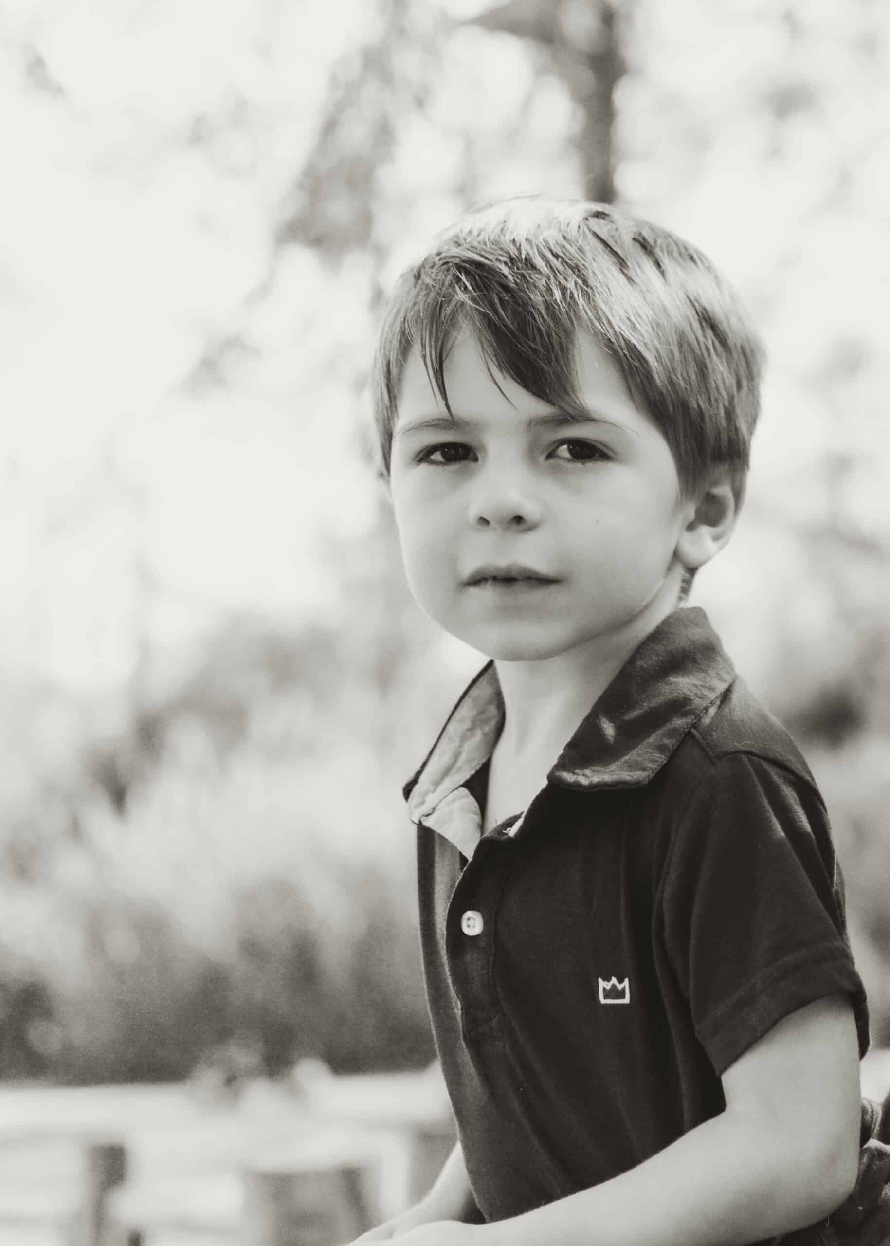 Boy posing for photo with Andrea Angles Madison AL Family Photography in Madison AL. Black and white picture of boy looking at camera