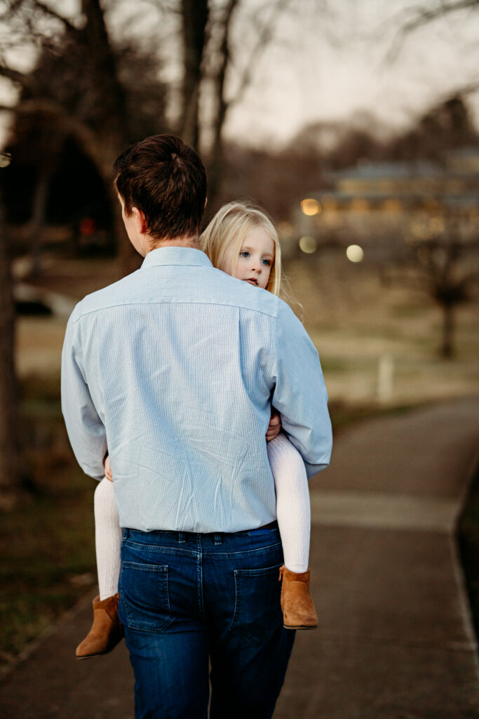Dad and her daughter walking away from camera in a family photography session in Huntsville Alabama