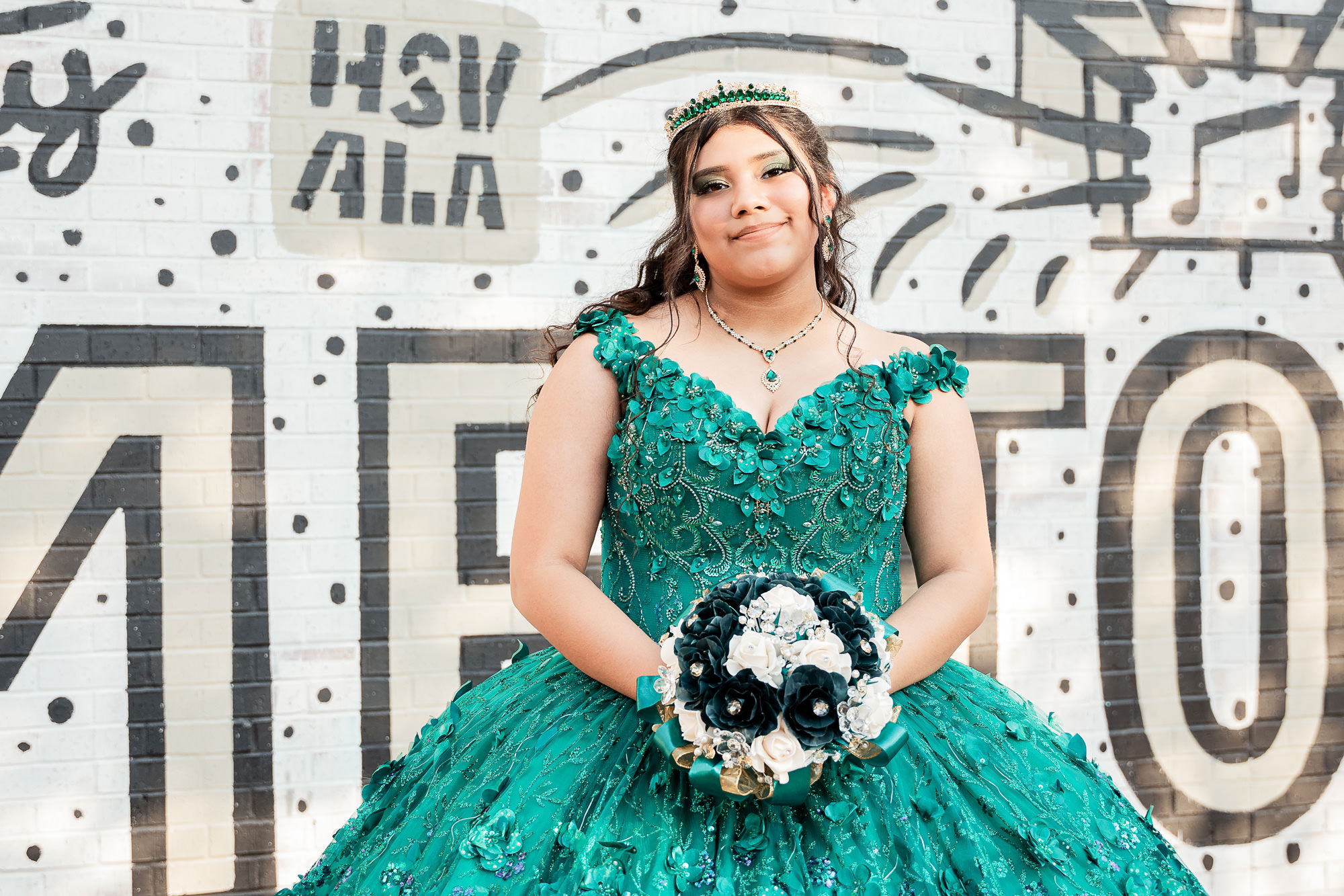Madison AL Event Photographer, Andrea Angles Photography. Quinceanera posing for a photoshoot at Big Spring Park Alabama wearing a green dress
